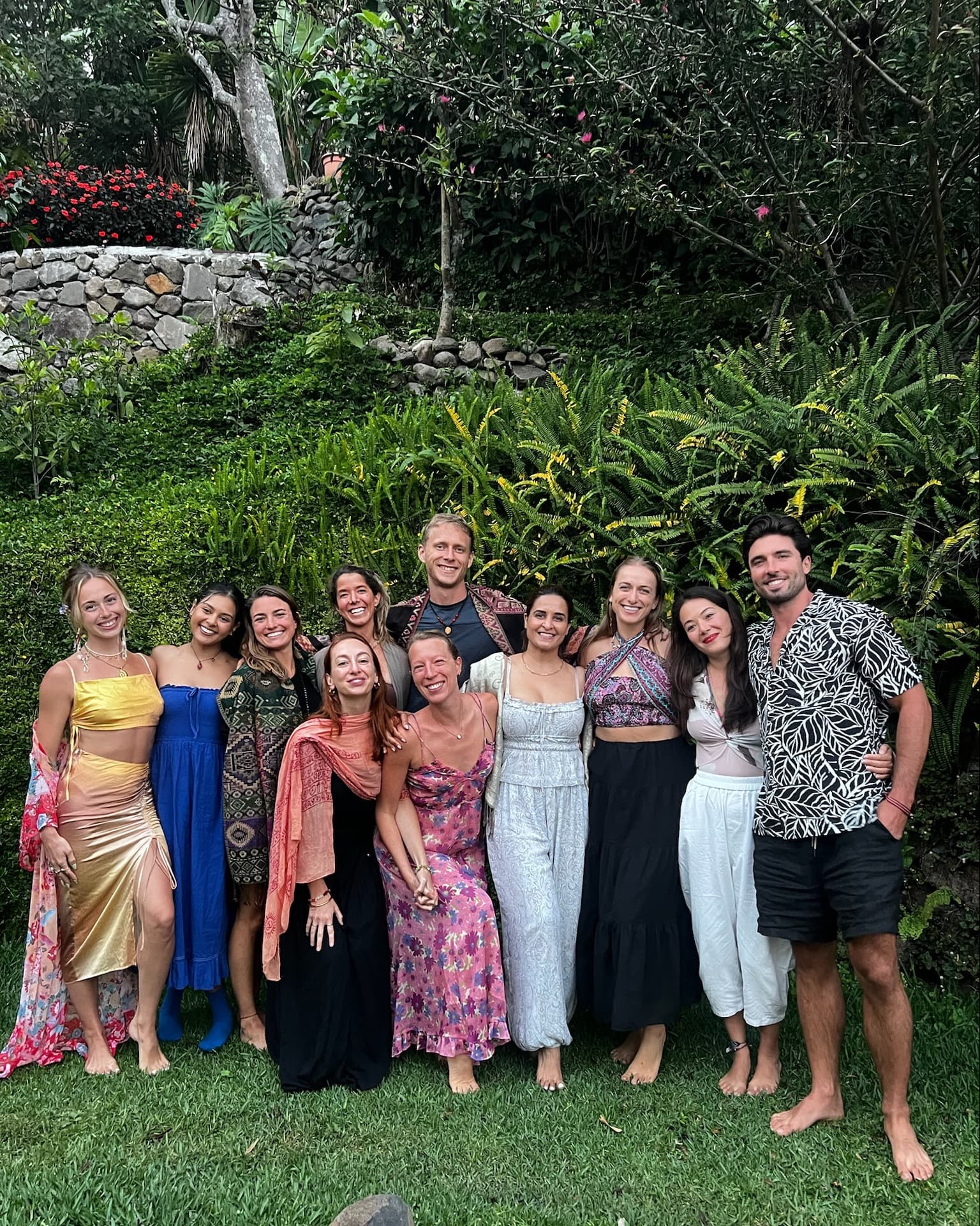 Alix with her teacher-training cohort, gathered in a garden at dusk